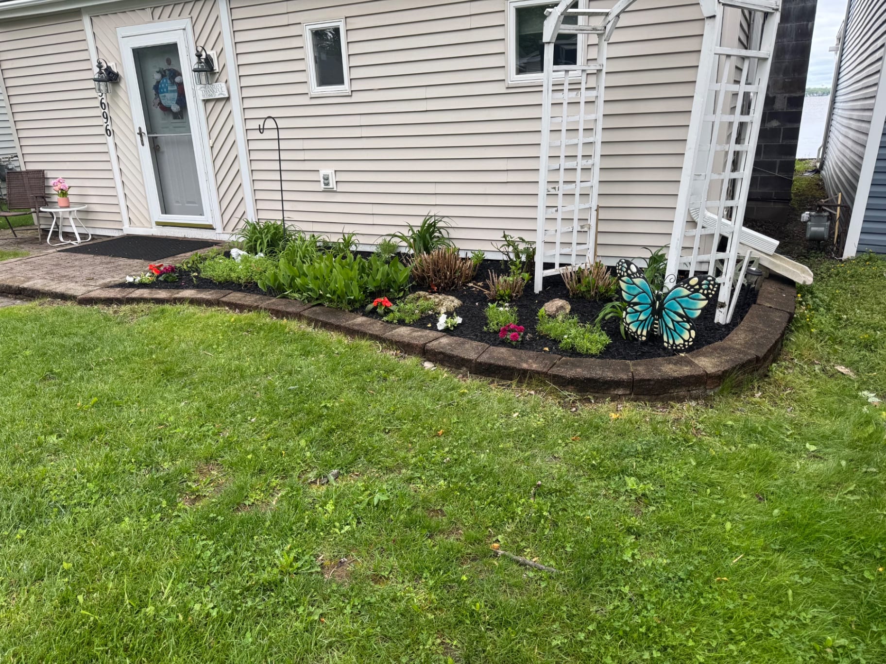 Front foundation bed refreshed with mulch and flowers