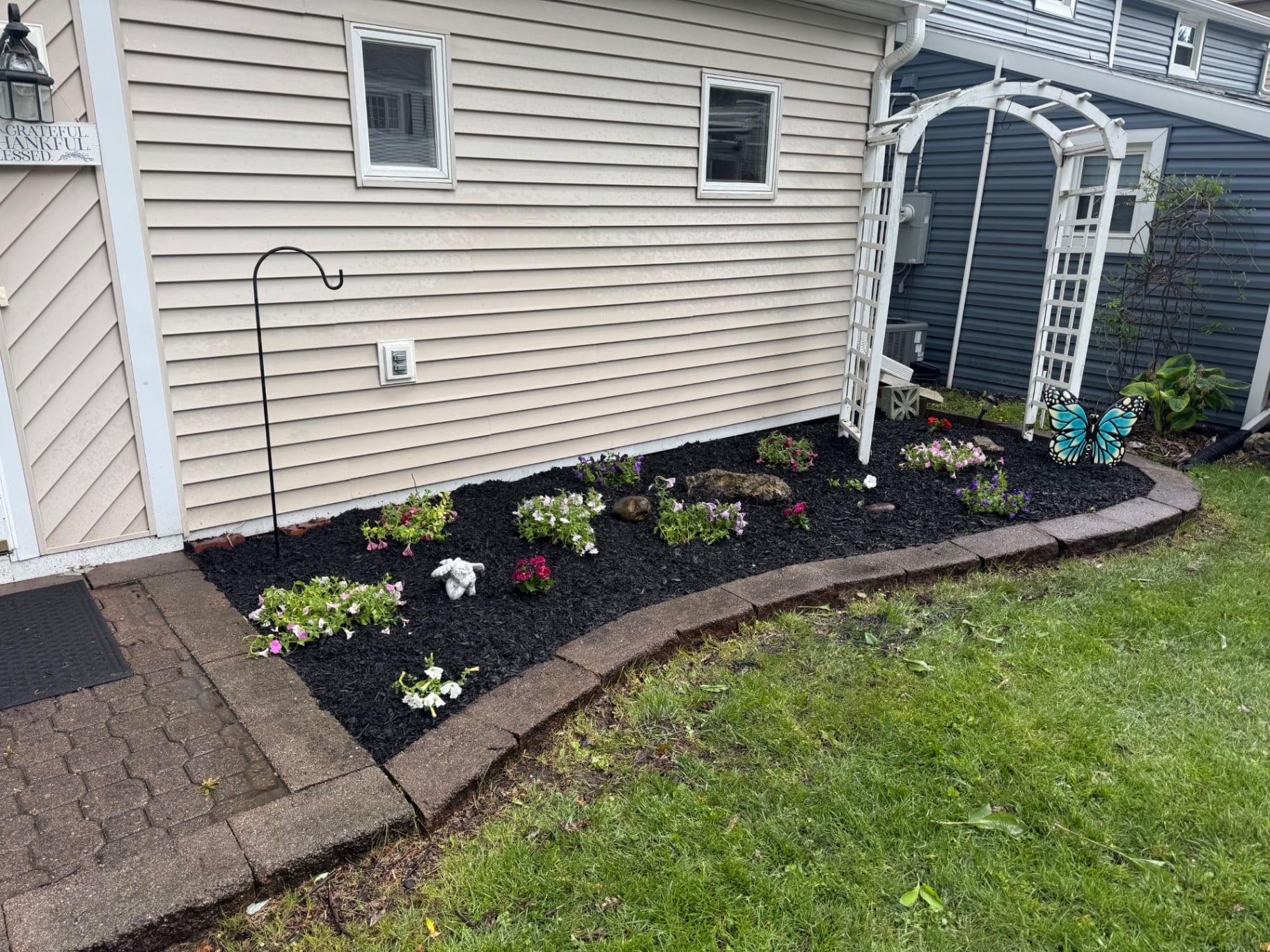 Finished flower bed with black mulch and colorful plantings