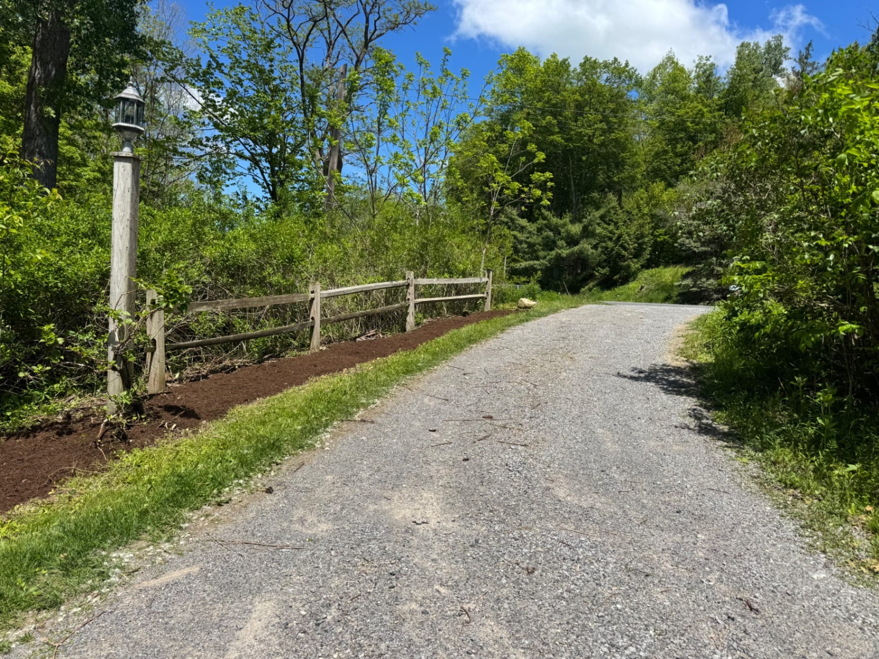 Gravel driveway and refreshed mulch border after cleanup